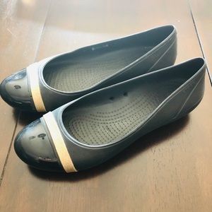 Never worn black with gold stripe Croc flats